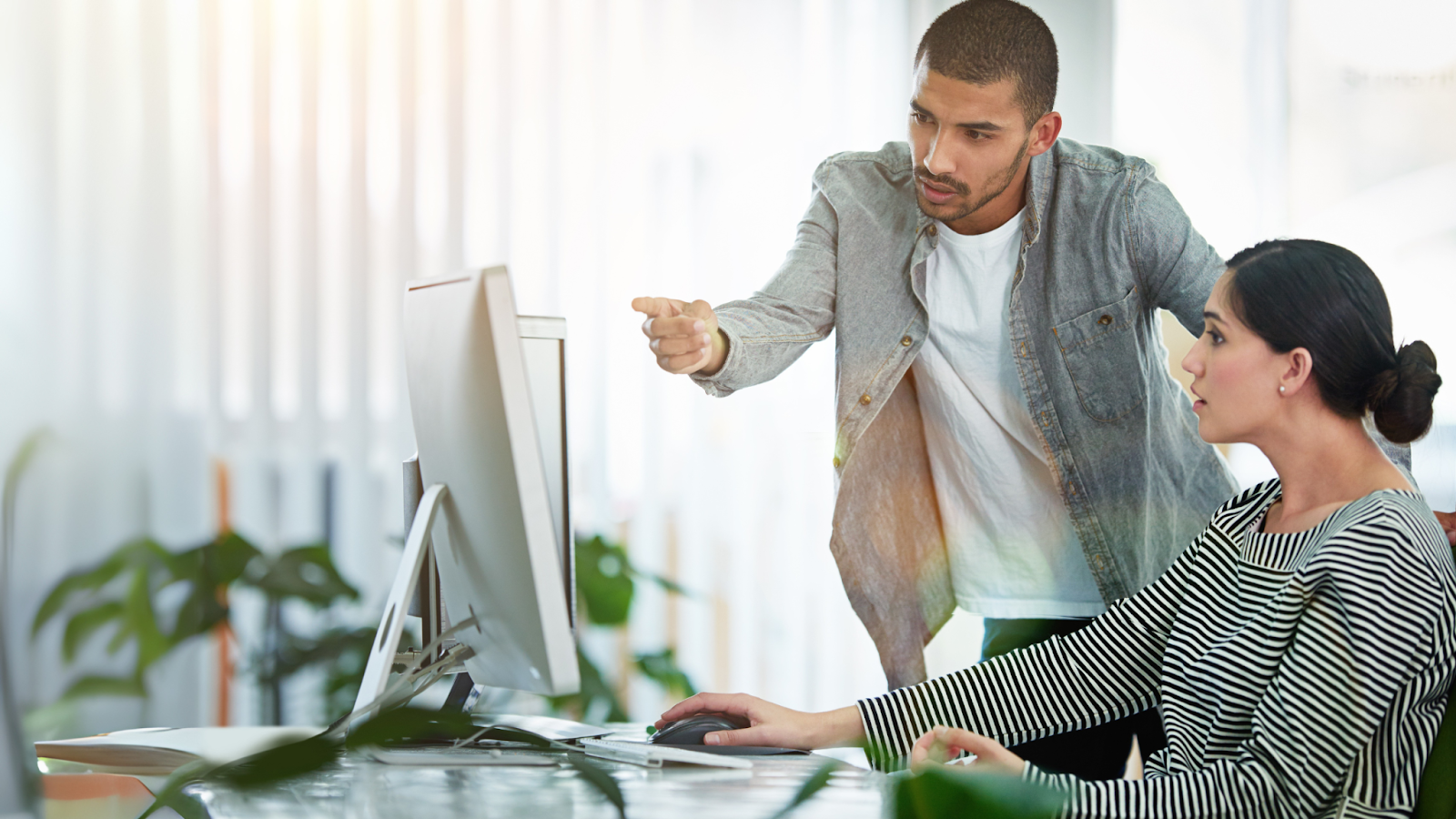 Real estate professionals collaborating on transaction details, highlighting the value of transaction coordinators in improving team productivity and workflow.
